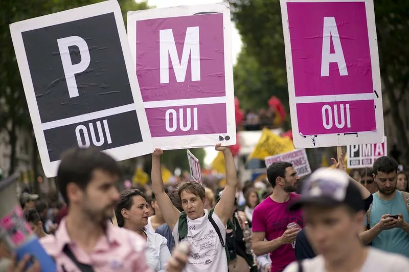 Photo d'une manif avec des femmes brandissant des pancartes PMA Oui Oui Oui